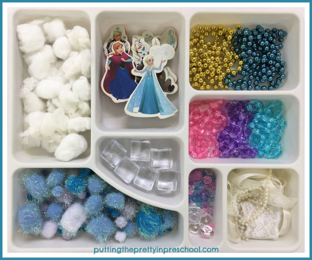 Frozen inspired loose parts tray. Invitation for children to create a scene and engage in pretend play.