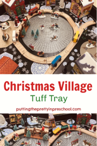 An inviting, snowy pioneer Christmas village tuff tray filled with people participating in outdoor winter activities.