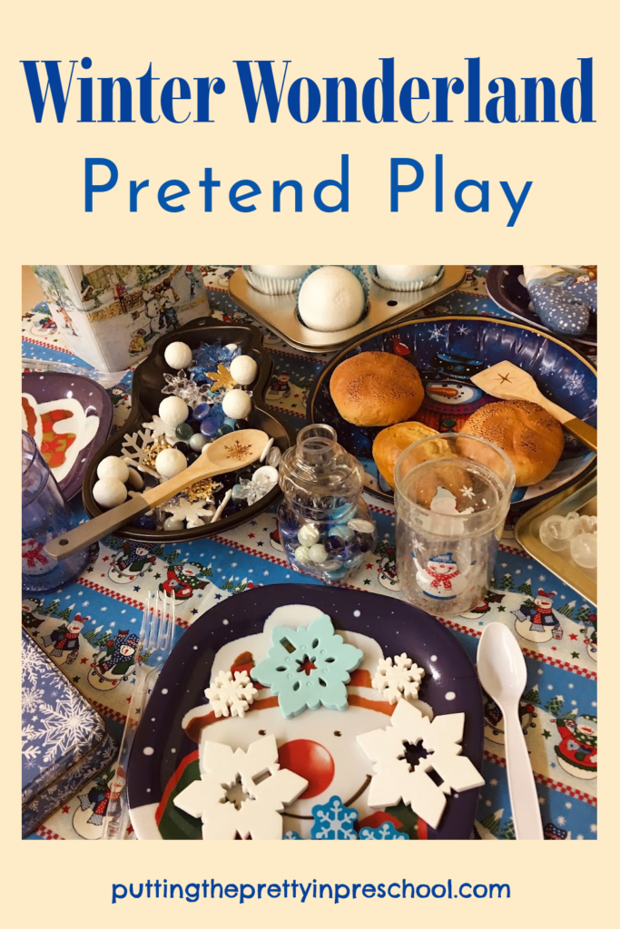 A sparkly, kids' Winter Wonderland pretend play setup with snowman, snowflake, and snowball play kitchen decor for little learners to explore.