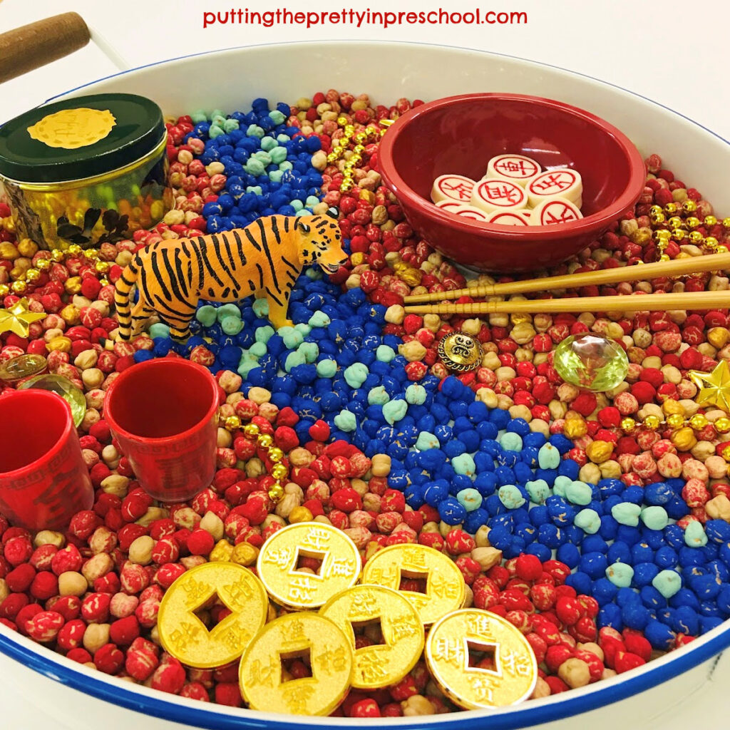 This chickpea-based sensory bin has a "Year Of The Tiger" Chinese New Year theme.
