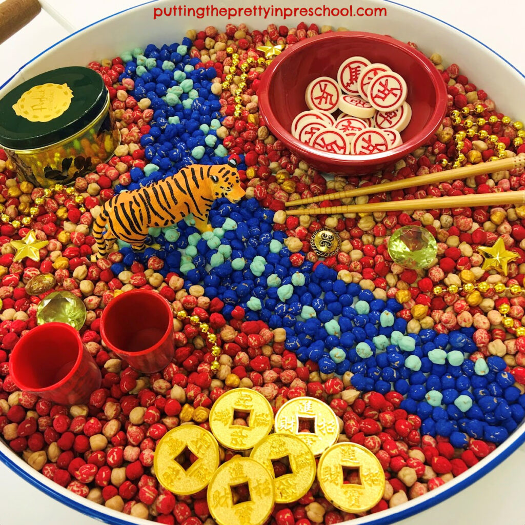 The tiger is center stage in this "Year Of The Tiger" Chinese New sensory bin.
