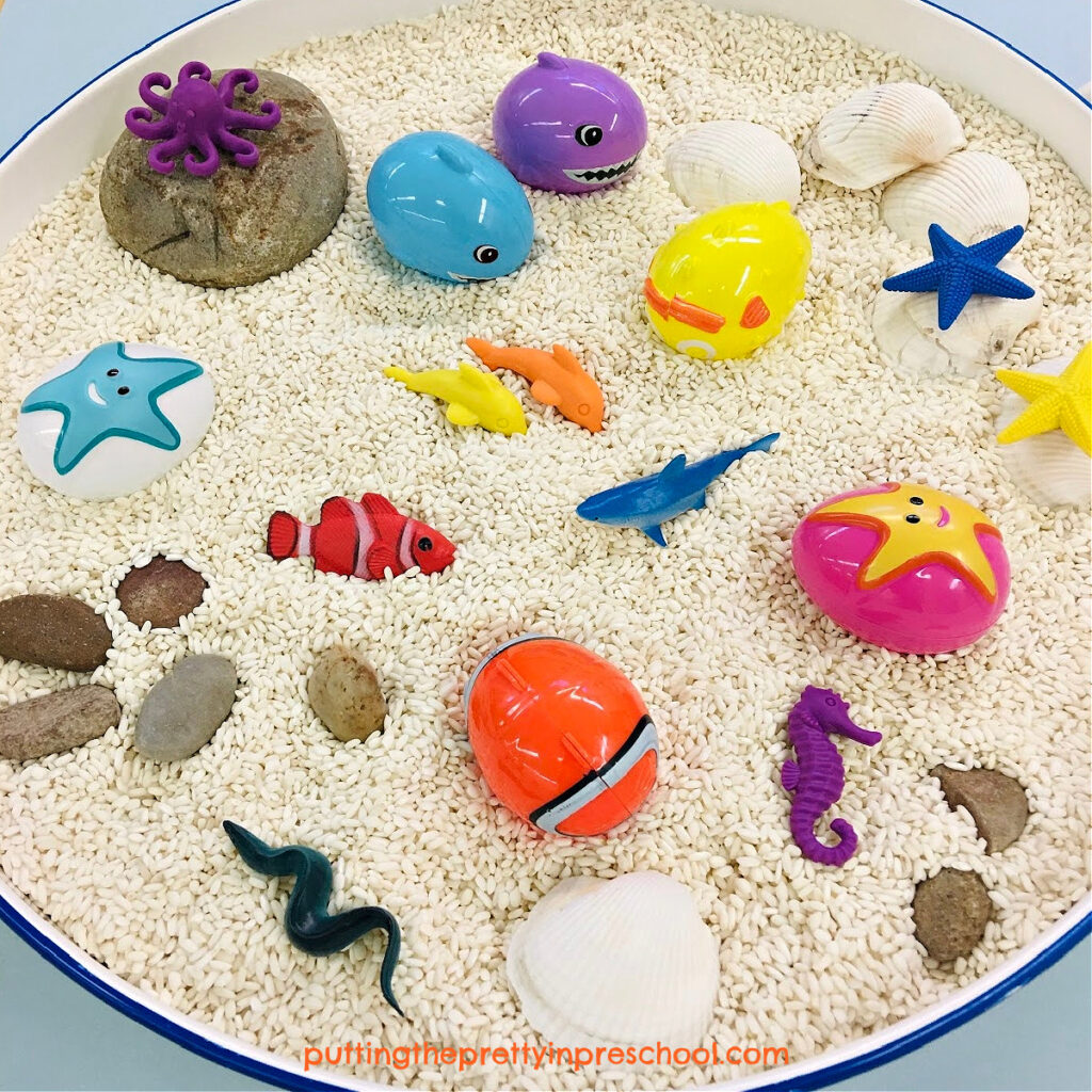 Set up this easy and fun rice-based ocean sensory bin. Aquatic Easter eggs are the highlight of the play invitation.