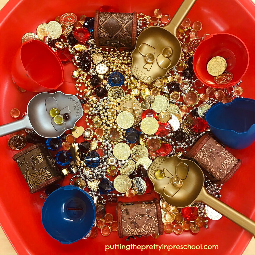 A gold and gem-filled pirate treasure sensory bin your little mateys will be eager to explore.