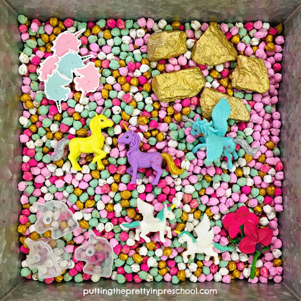 Set up this attractive unicorn theme sensory play tray using dyed chickpeas as a base. Use acrylic craft paint for an easy dye process.