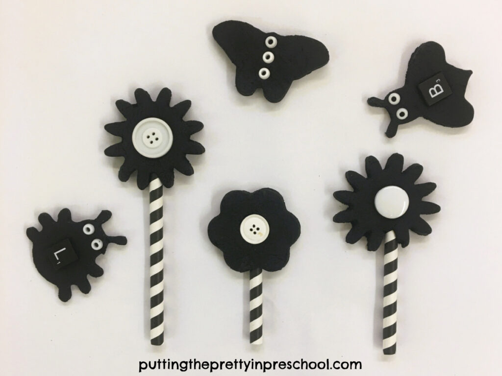 An striking black and white playdough theme with flower, bug, and butterfly cookie cutter shapes.