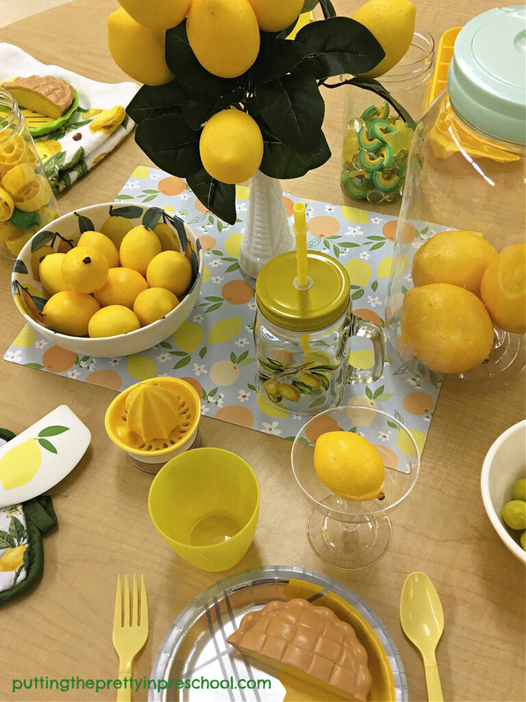 This lemon-inspired kids' play tablescape can be set up any time of the year. Loose parts complement the lemon theme.