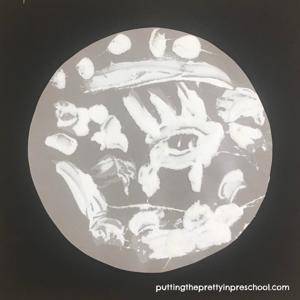 An easy-to-do moon art activity with a salt and glue technique. The art project looks stunning on display.