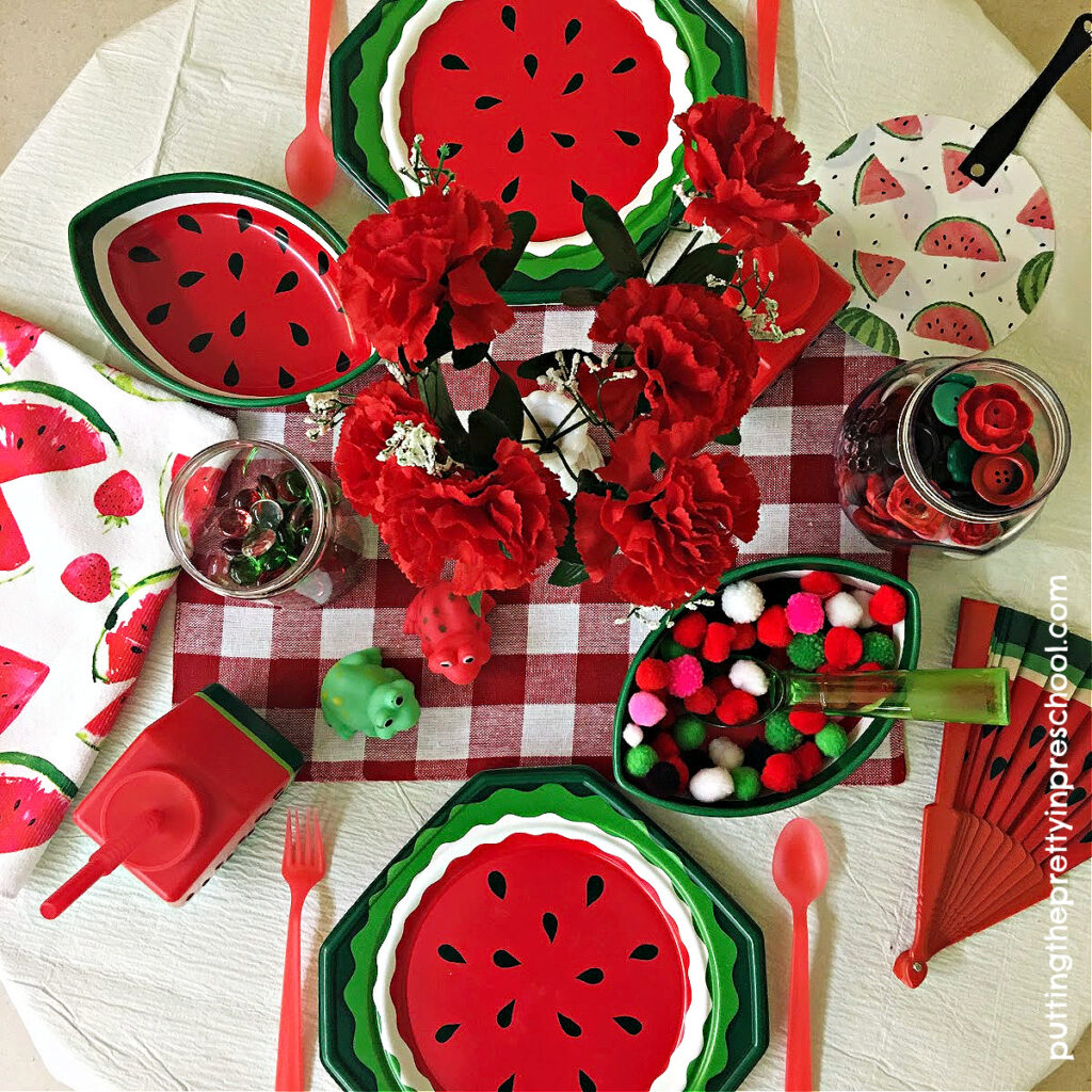 Watermelon-themed picnic tableware and loose parts add a welcome burst of color to a dramatic play center.