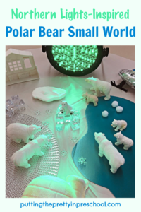 A professional stage light adds ambiance to this inviting northern lights-inspired polar bear small world.