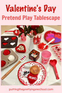 This simple and pretty Valentine's Day pretend play tablescape is filled with hearts and red and white loose parts.